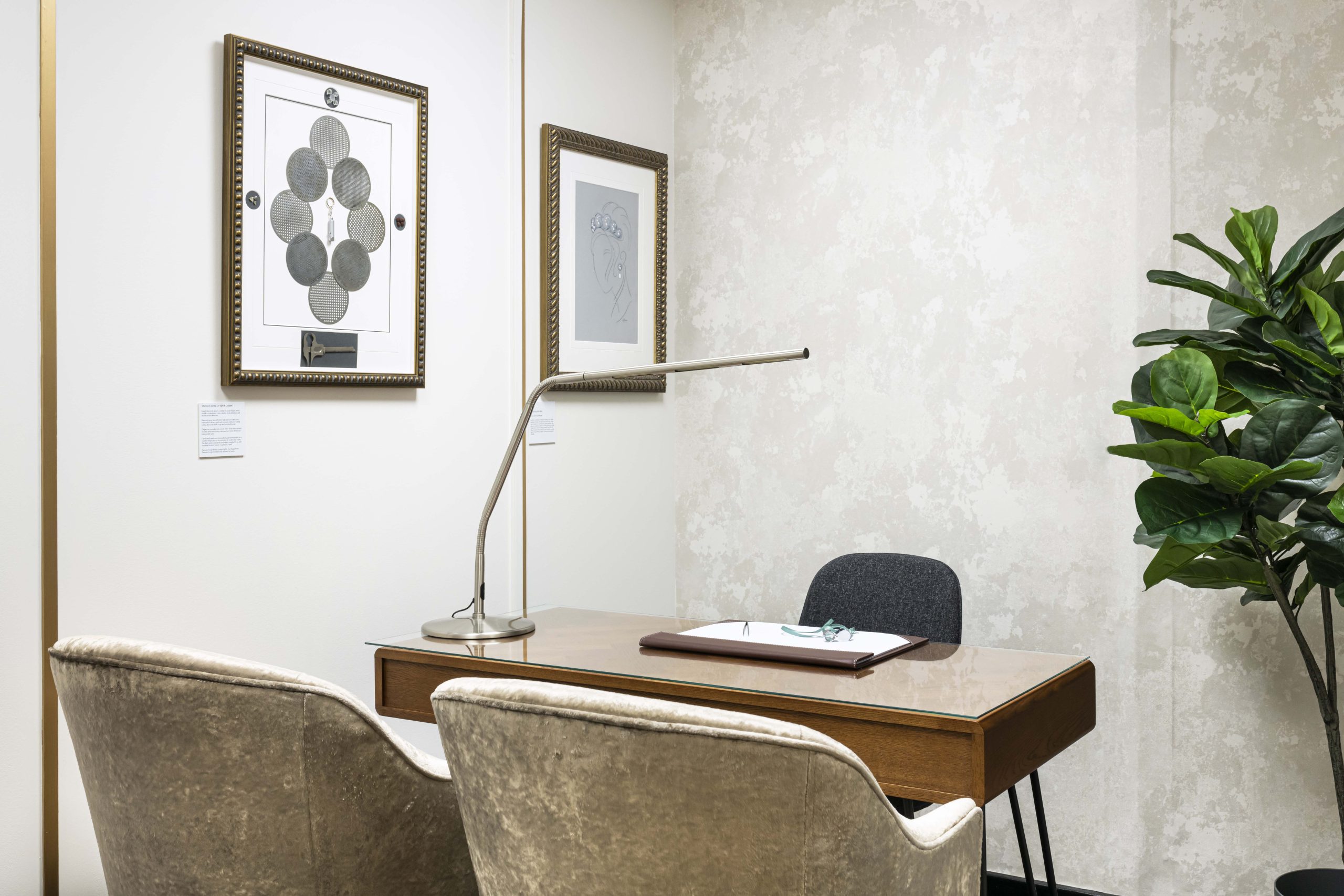 An adjustable daylight lamp positioned over a bare desk in one of the viewing rooms