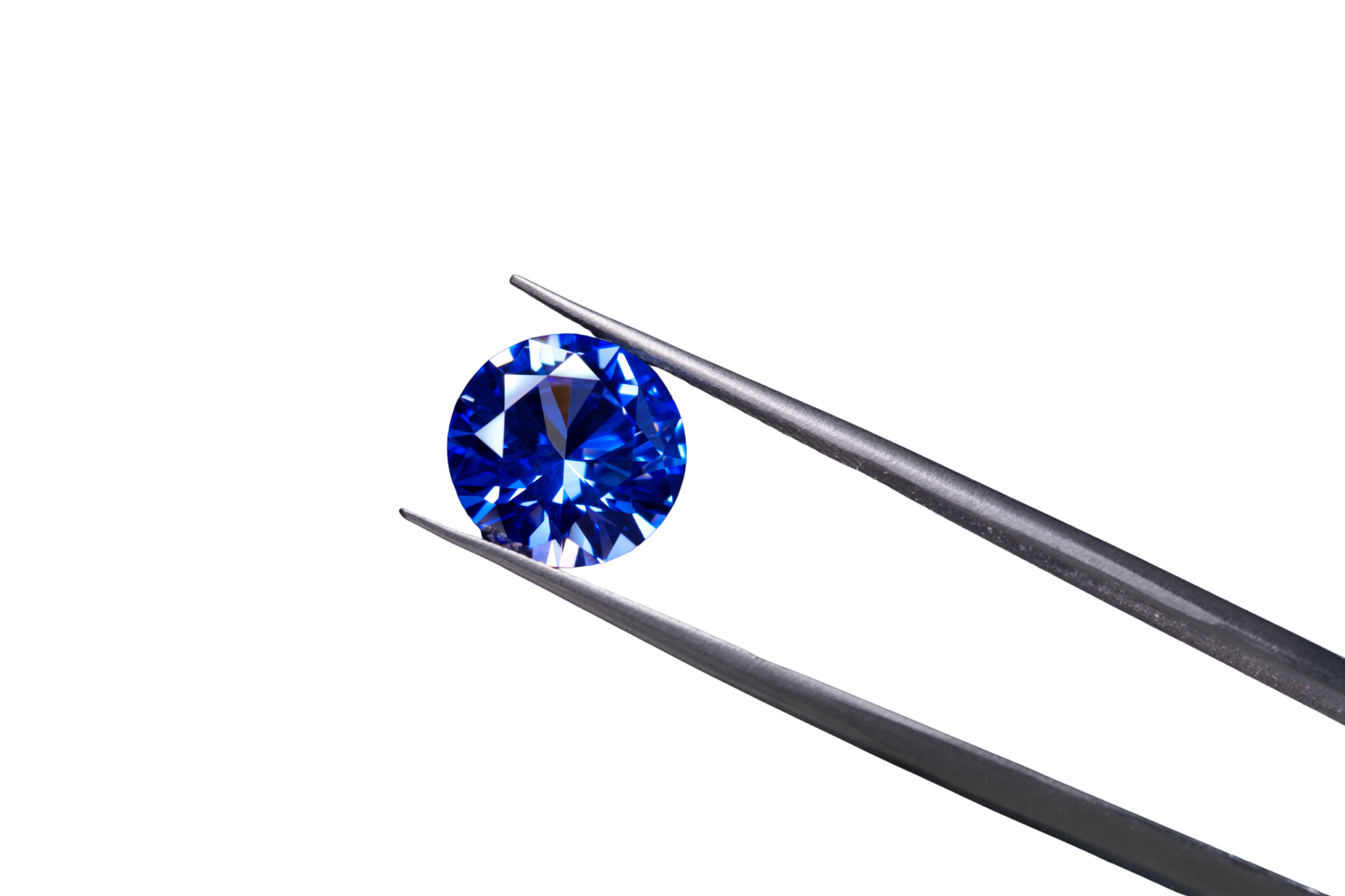 Sapphire gemstone held by tweezers